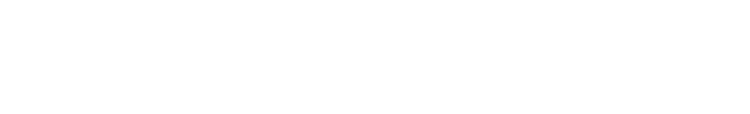 A sign that says "Round Hill Creek Apartments".